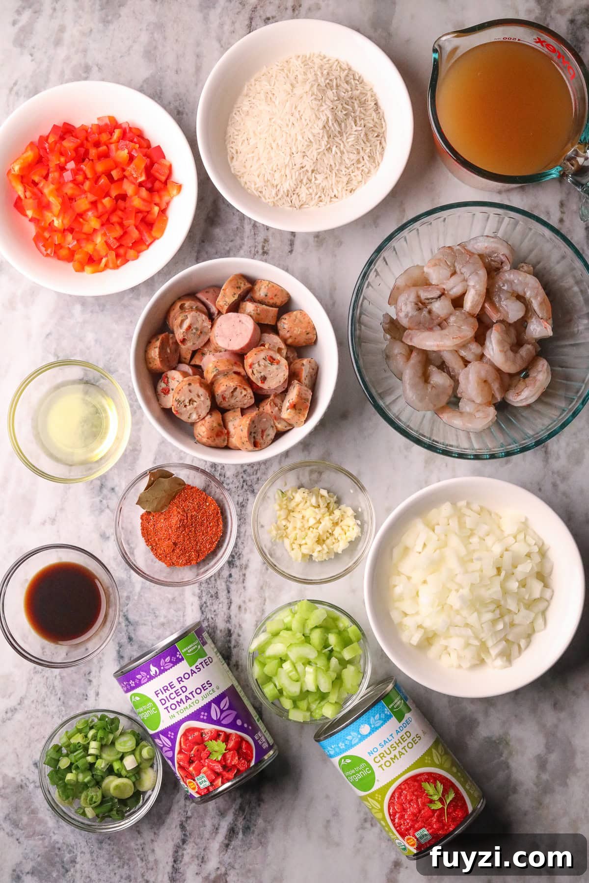 Ingredients for shrimp and sausage jambalaya arranged in bowls