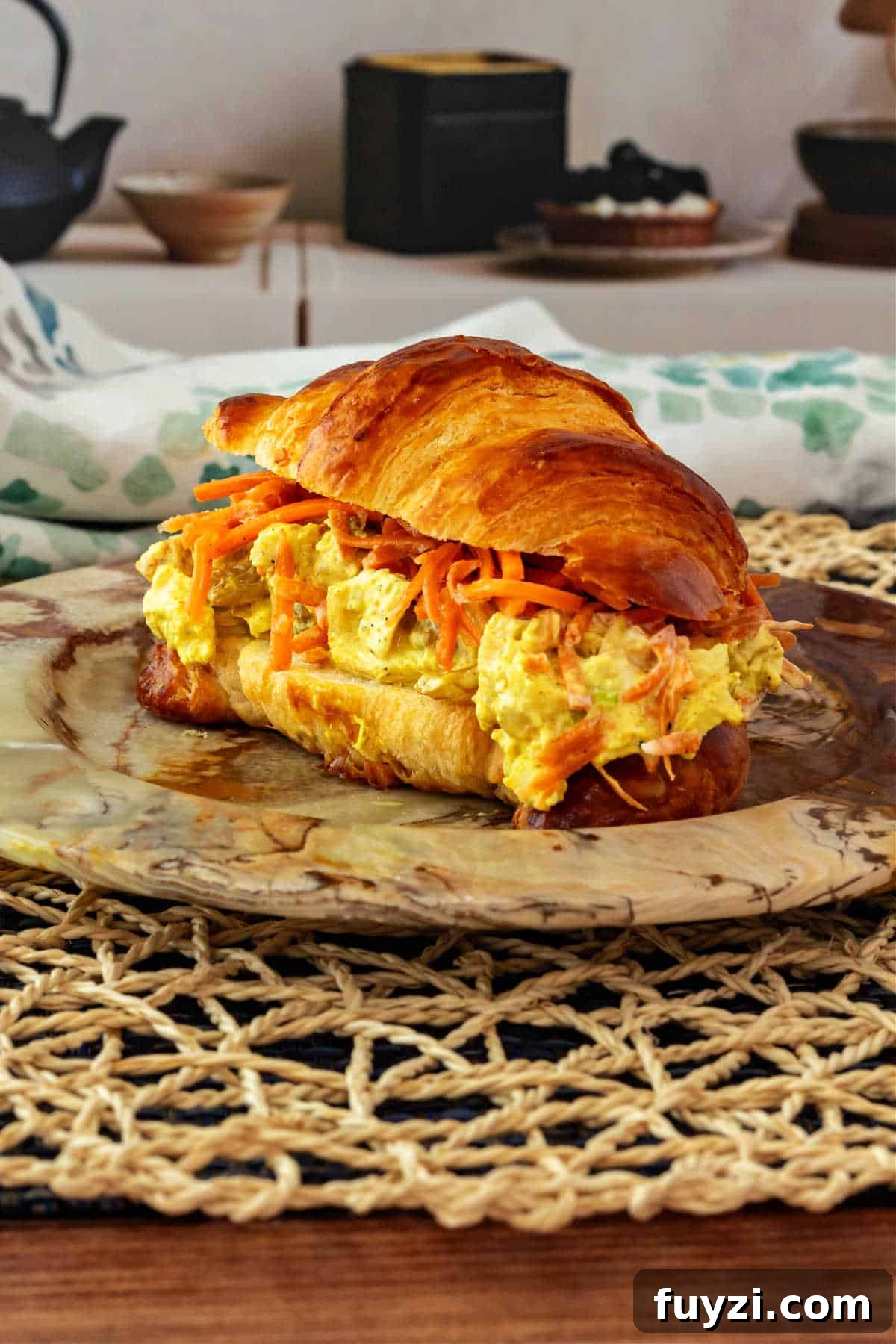 A chicken salad sandwich made on a split croissant