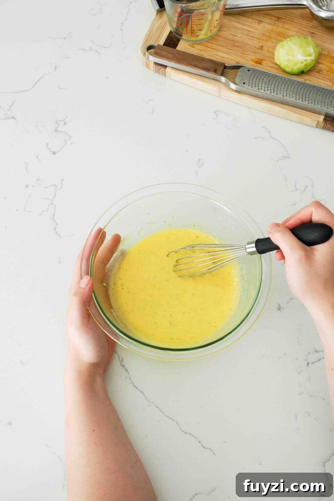 Uncooked mango curd is whisked together.