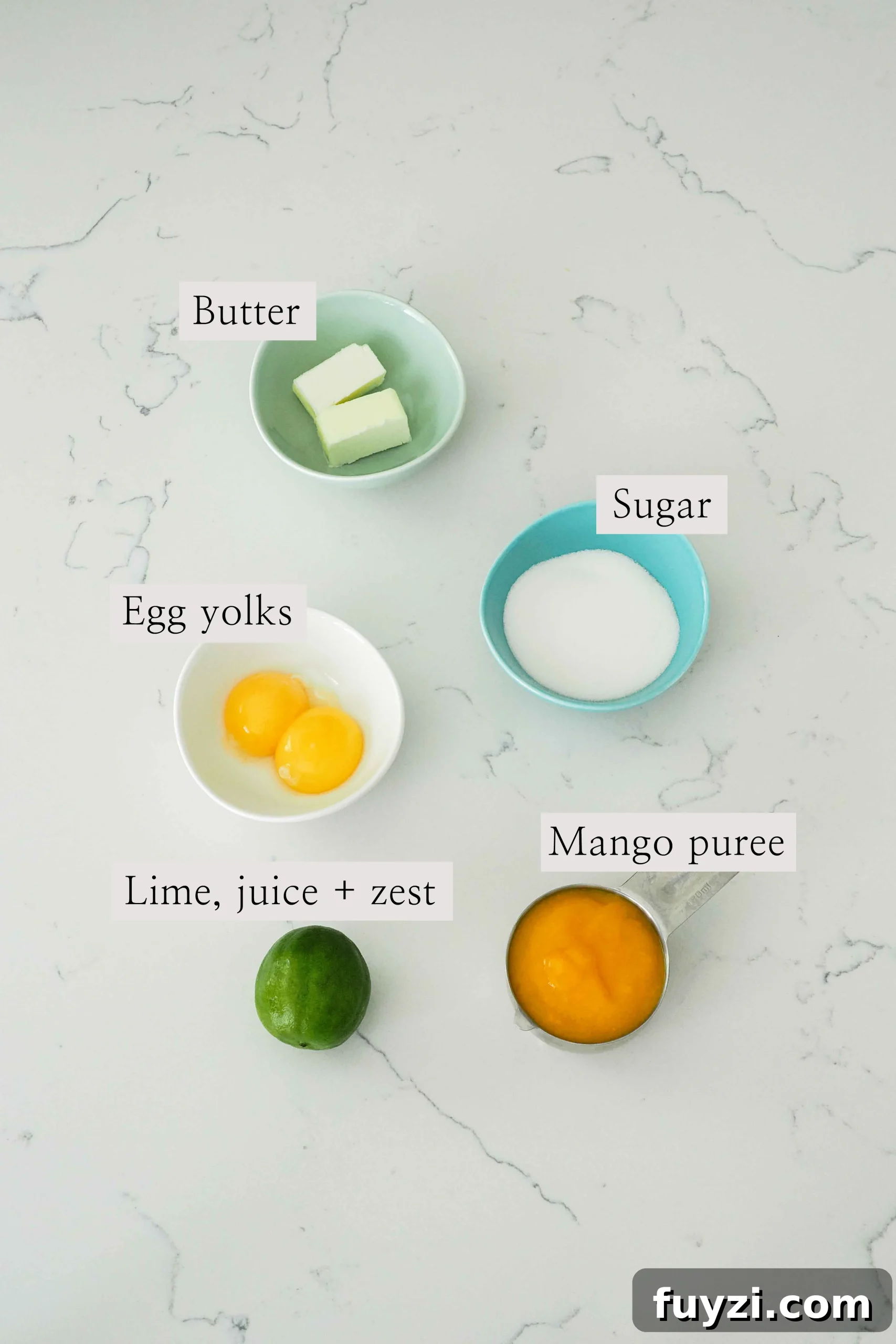 Ingredients for small batch mango curd on a quartz countertop.