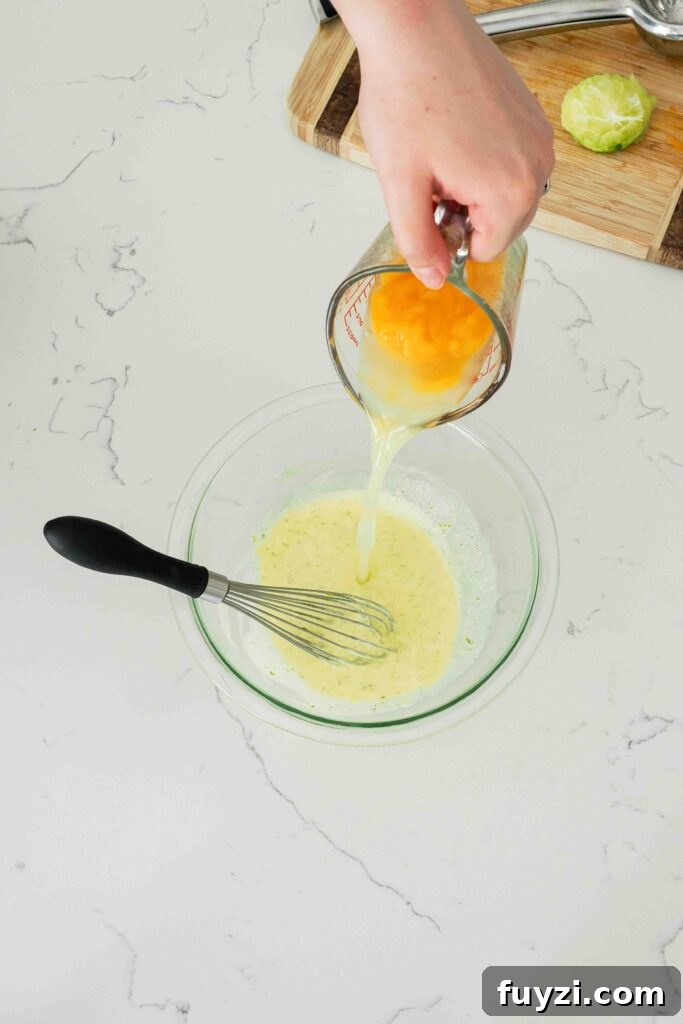 Lime juice and mango puree is poured into ribboned yolks.