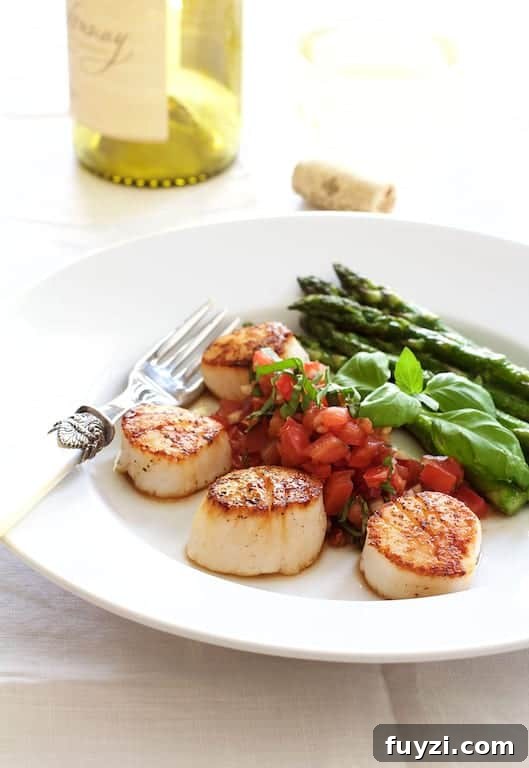 Photo of Seared Sea Scallops with Tomato, Red Onion and Balsamic Salsa with asparagus on white plate.