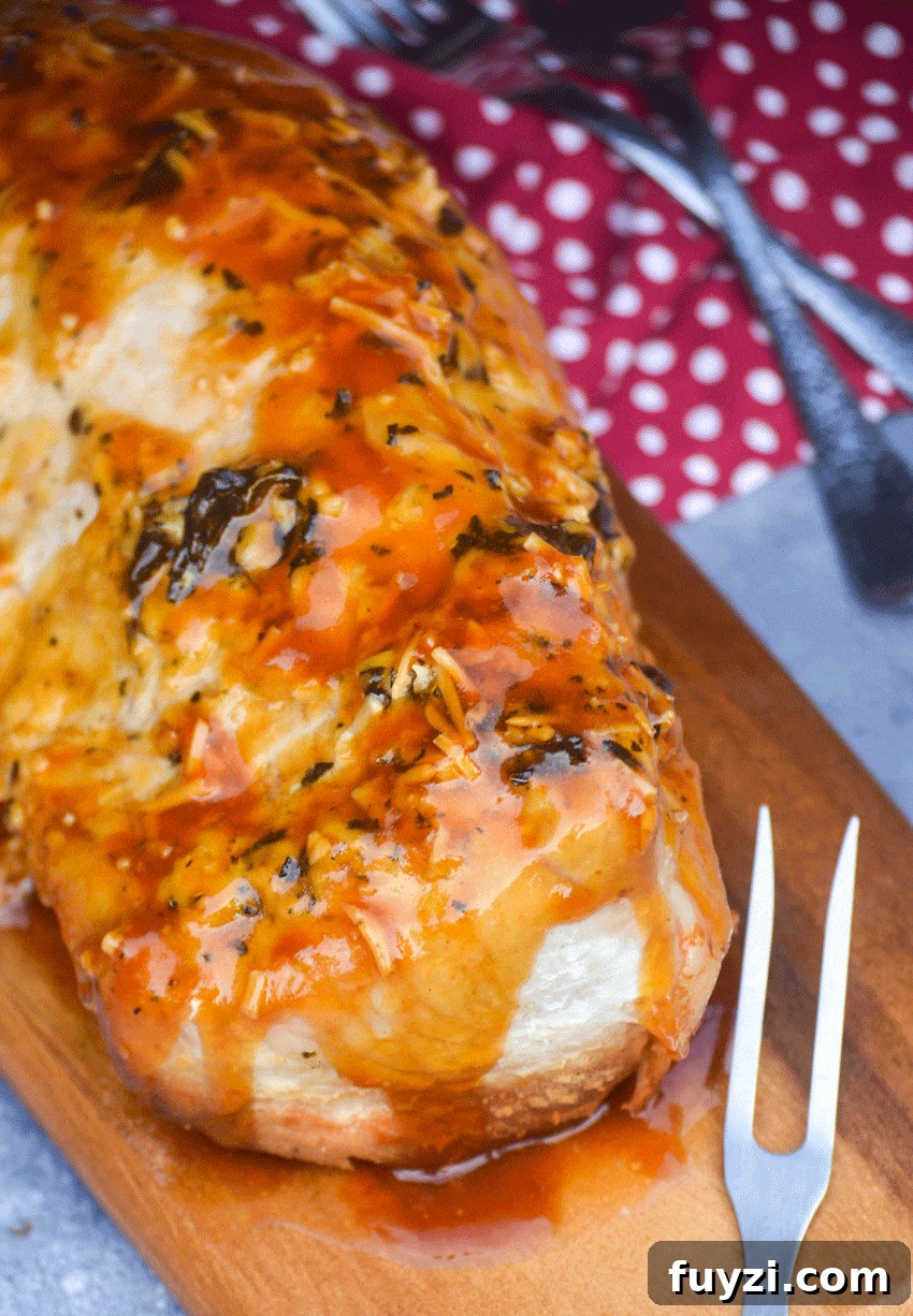 honey garlic sauced pork tenderloin slow cooker recipe on a wooden cutting board