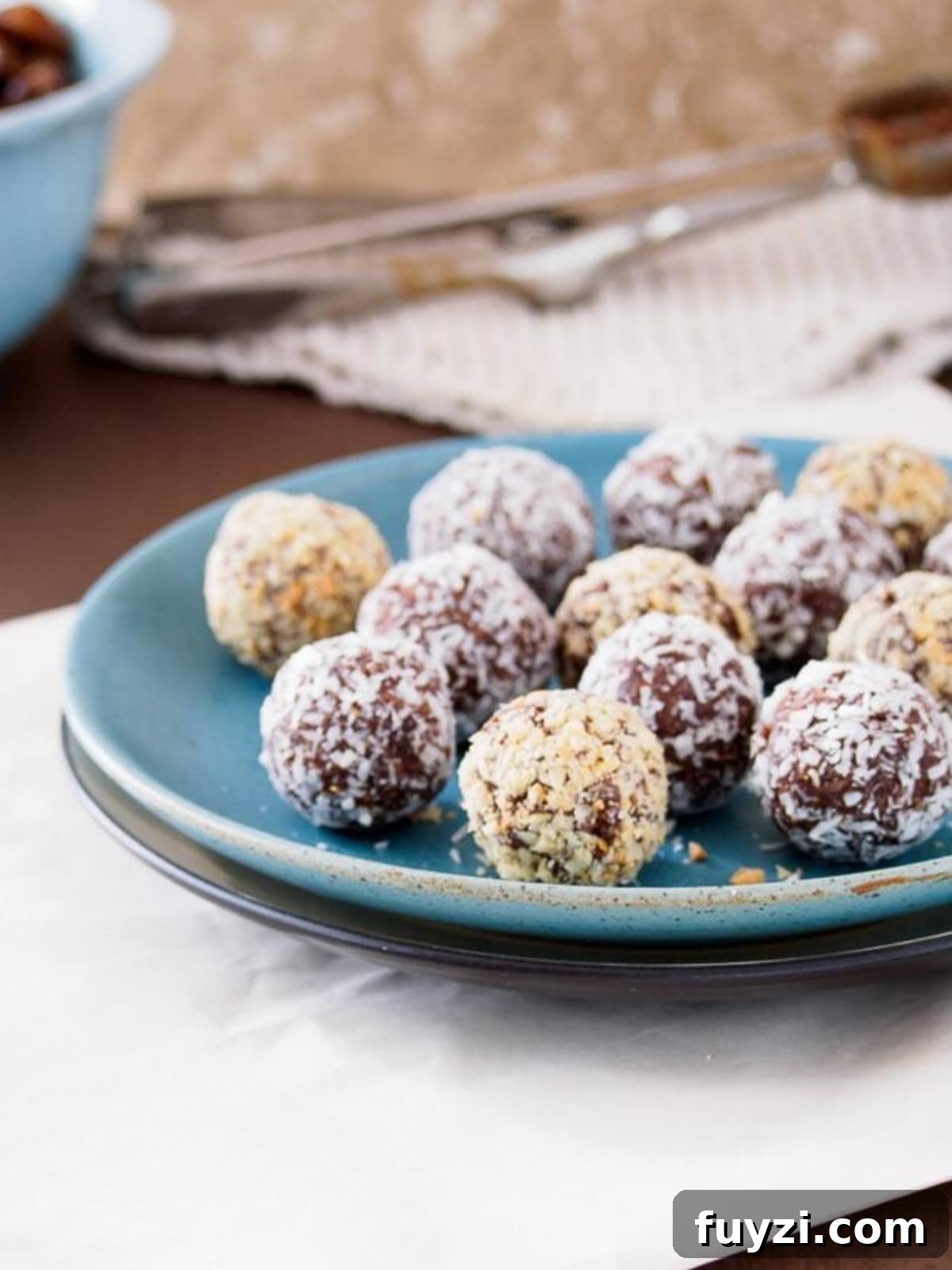 5-Ingredient Date Energy Balls Recipe: No-Bake Snack 4 Energy balls made with dates and peanut or almond butter on dish.
