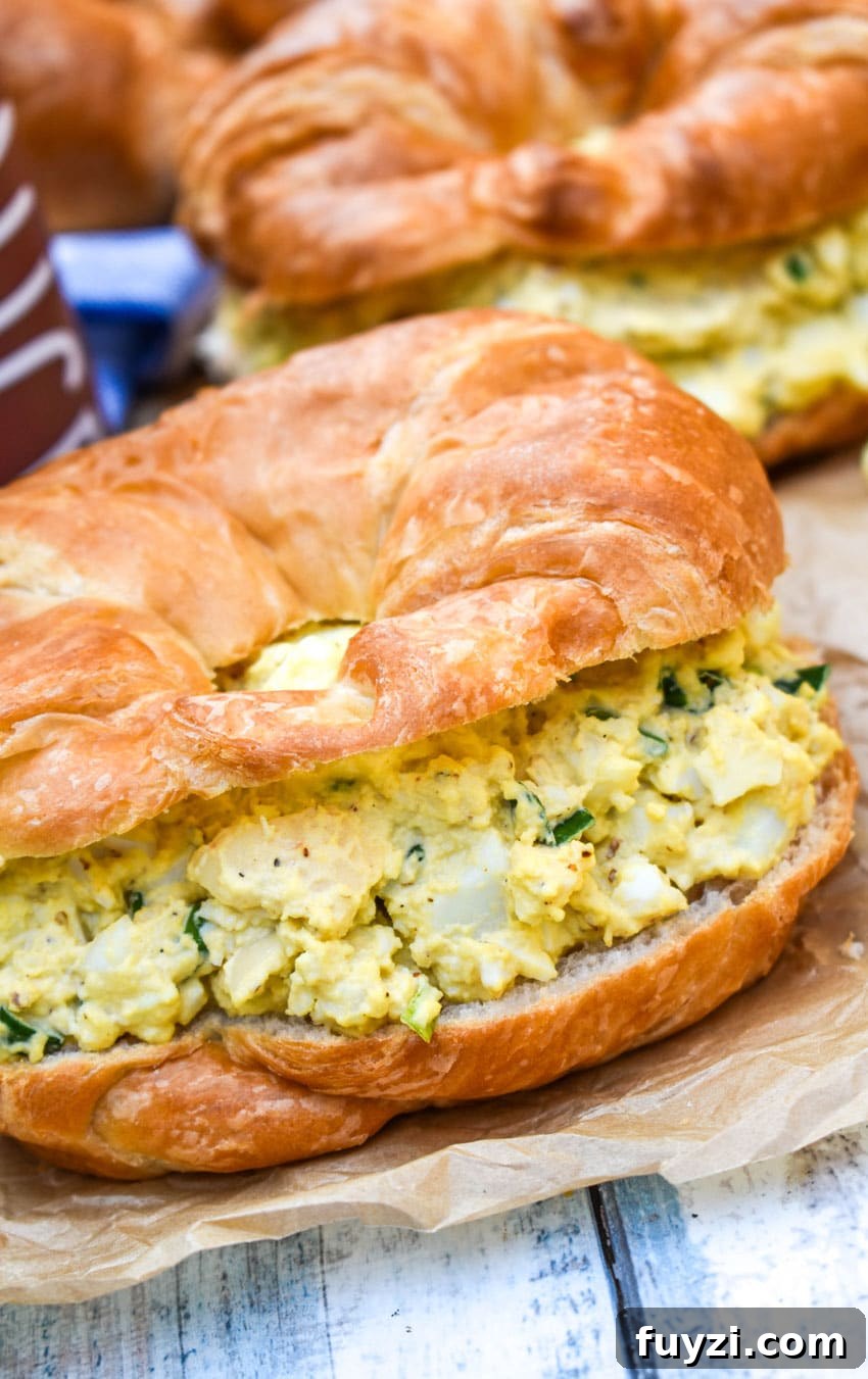 Smoked Egg Salad Recipe for Sandwiches and Salads 3 smoked egg salad on a croissant roll on wrinkled brown parchment paper