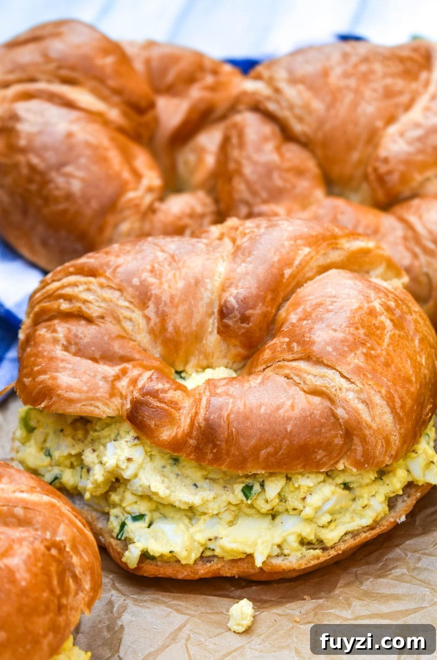Smoked Egg Salad Recipe for Sandwiches and Salads 4 smoked egg salad on a croissant roll on wrinkled brown parchment paper