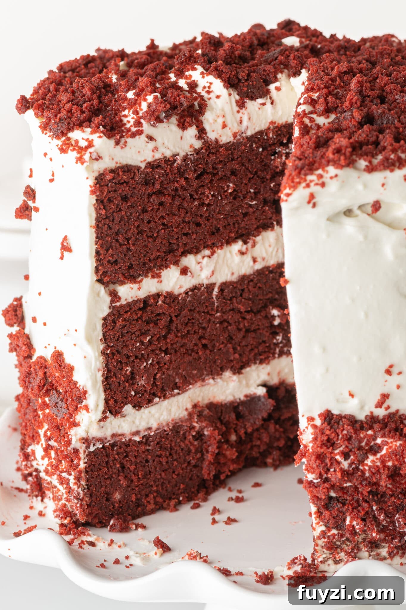 Low-Carb Red Velvet Cake Recipe with Cream Cheese Frosting 2 Low carb red velvet cake with white cream cheese frosting. A slice is a removed and you can see the maroon layers contrasted against the bright white frosting.