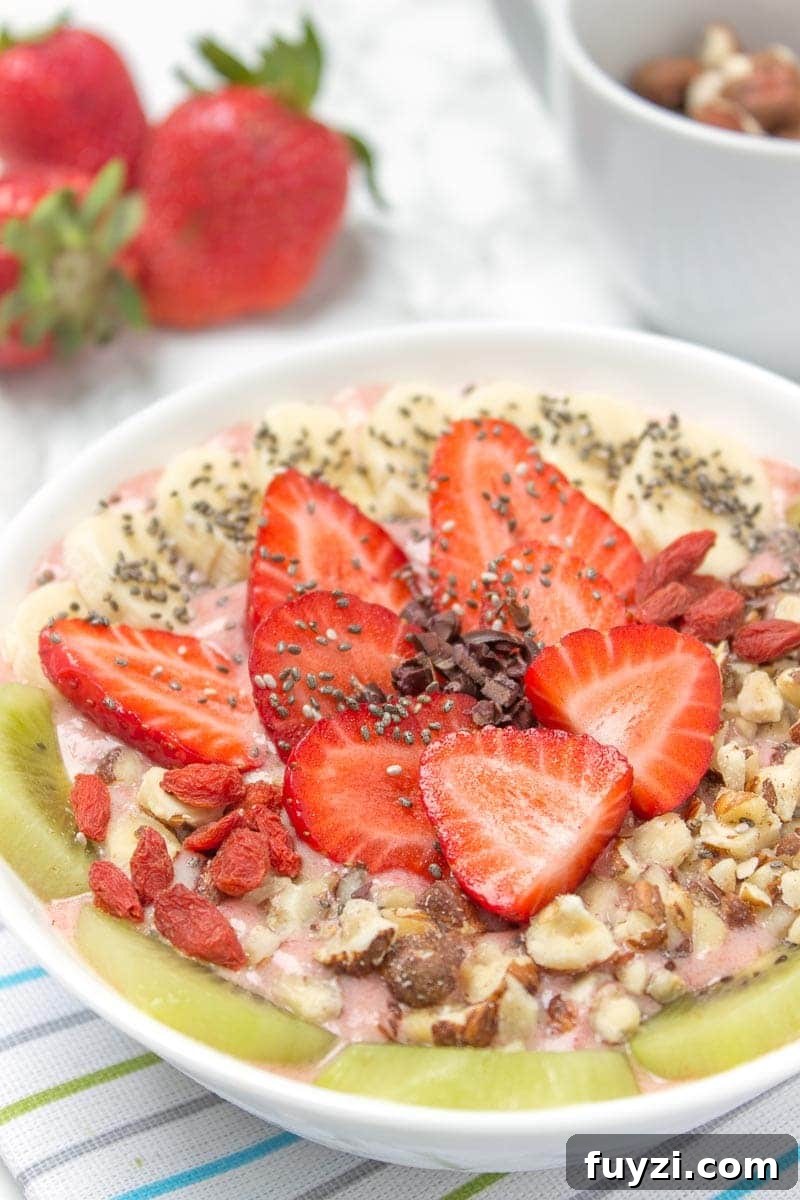 Strawberry Ginger Smoothie Bowl served fresh - bright pink color with toppings.