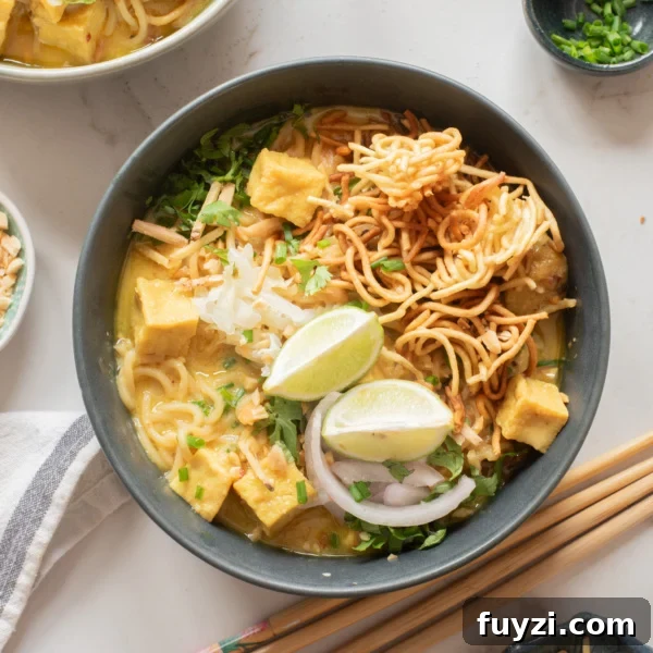 An overhead image of khao soi served in a bowl.