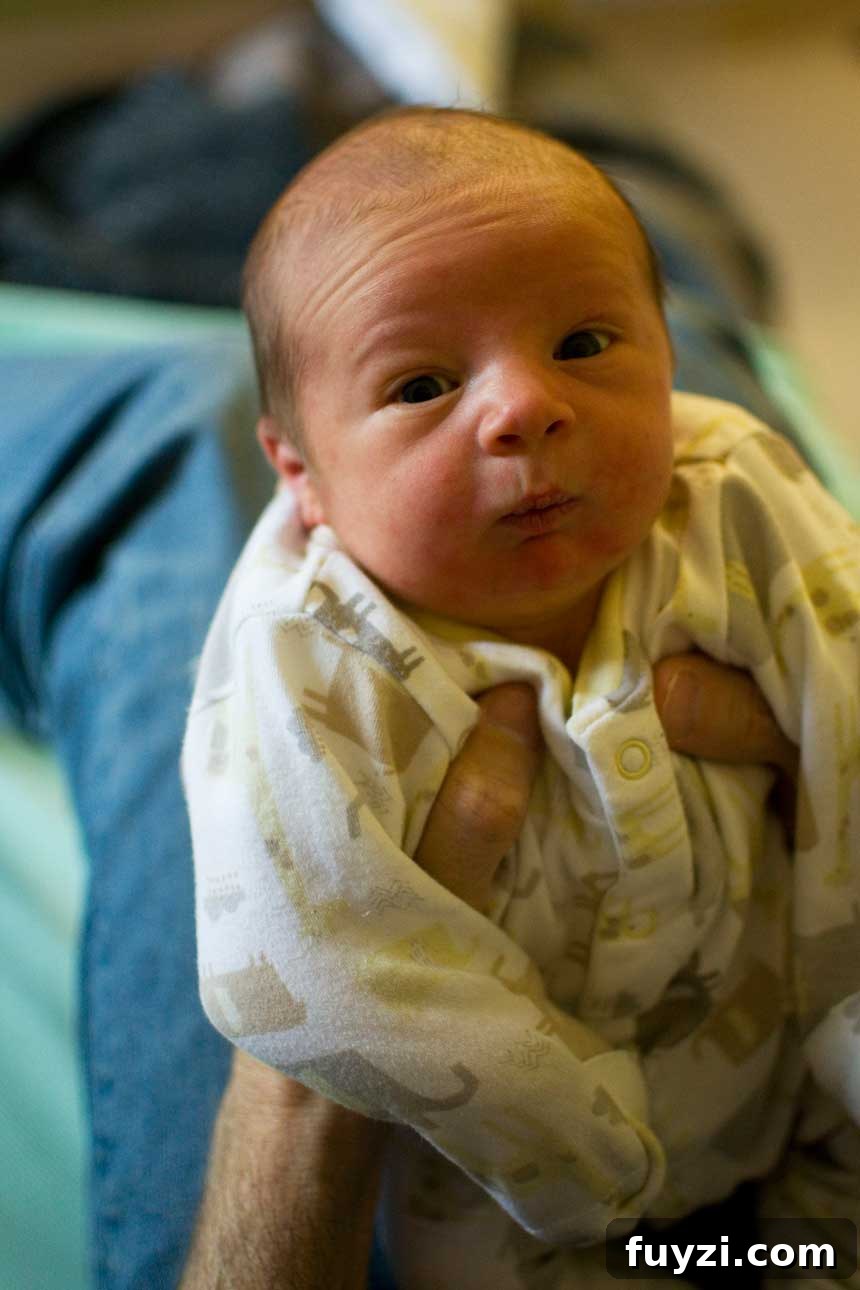 A person holding up a young baby.