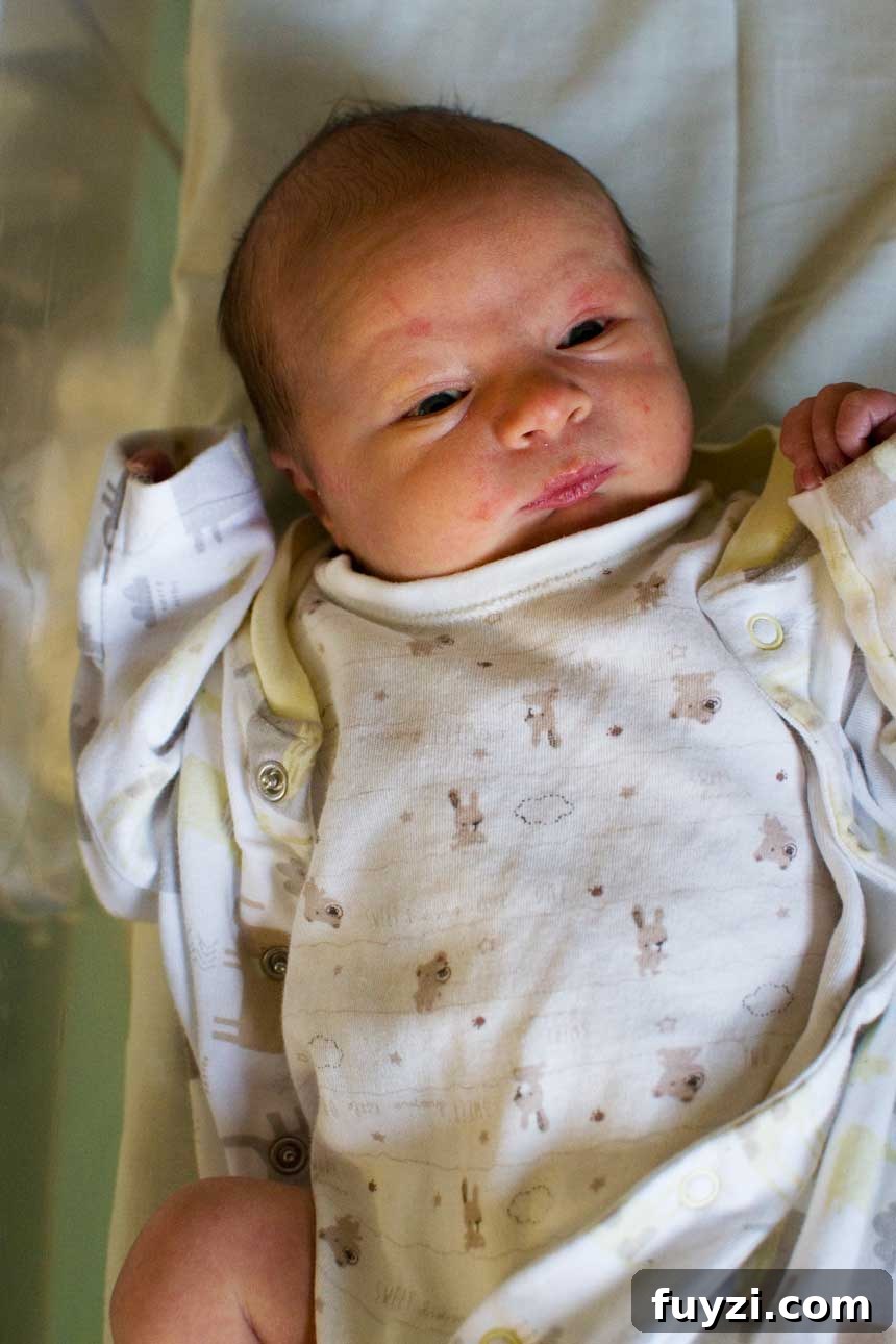 A baby lying in a bassinet.