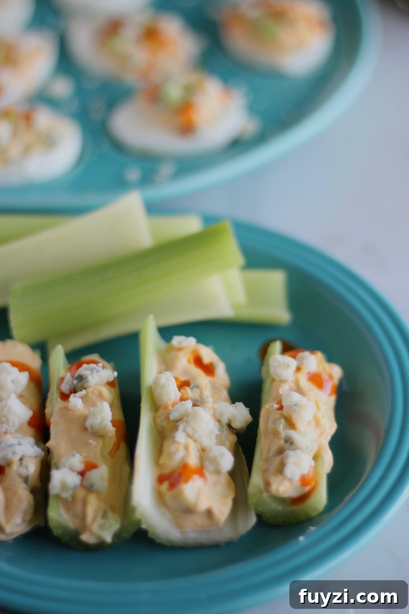 Buffalo Deviled Eggs - a hot and tangy deviled egg, with 5 ingredients, including hot sauce and blue cheese! Use the extra filling for a veggie dip! | fedandfulfilled.com