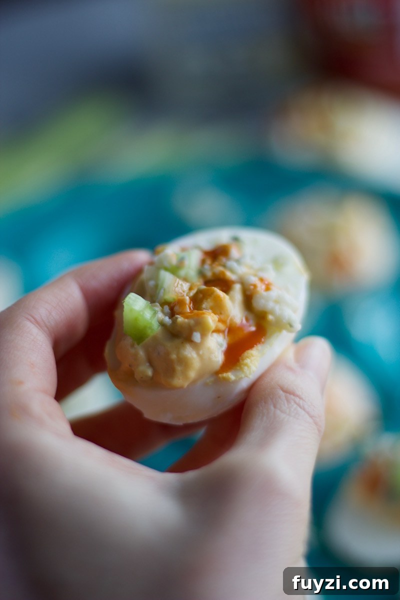 Buffalo Deviled Eggs - a kicked up deviled egg, featuring blue cheese, celery, and of course, hot sauce! | fedandfulfilled.com