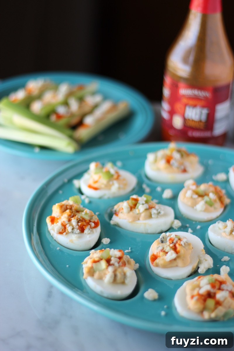 Buffalo Deviled Eggs - celery, blue cheese, and hot sauce take deviled eggs up a notch! So easy to make and super yummy! | fedandfulfilled.com