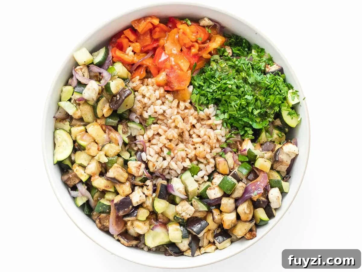 ingredients for mediterranean farro salad in a bowl