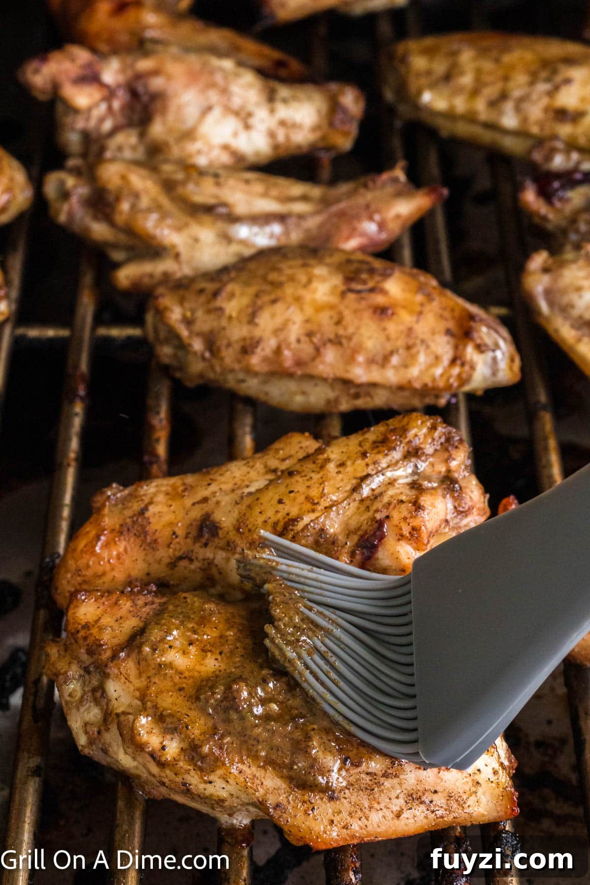 Basting the chicken wings with jerk sauce with a brush