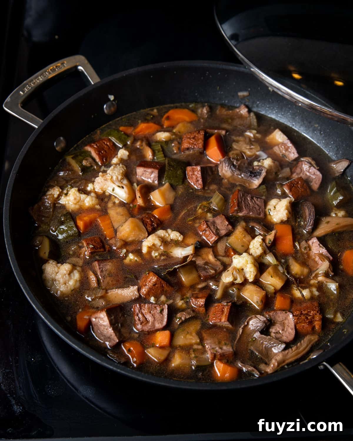 Vegan Smoked Tofu and Vegetable Stew 8 Photo of the cooked vegan stew still in the pan on the stovetop.