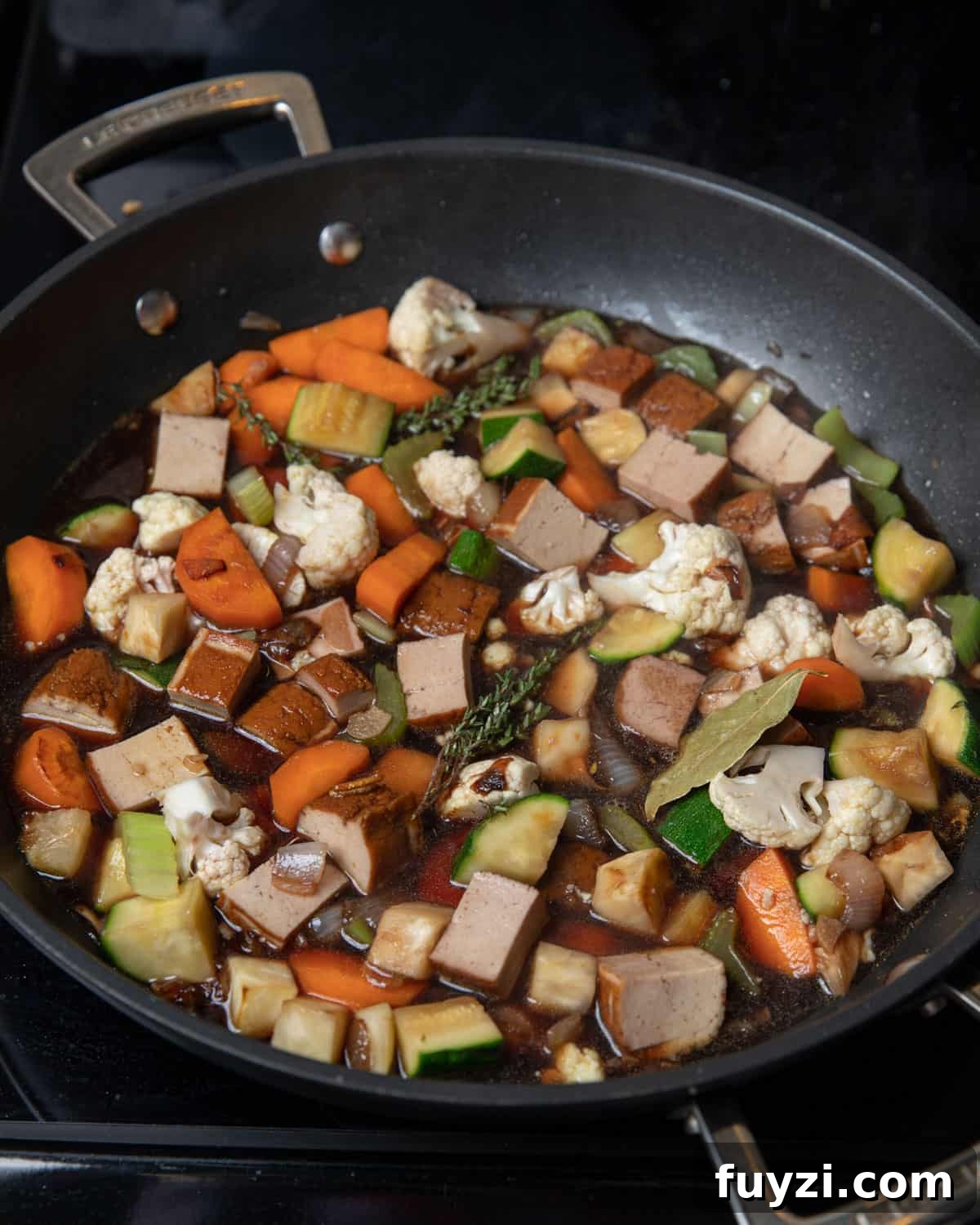 Vegan Smoked Tofu and Vegetable Stew 6 Photo of the rest of the ingredients being added to the pan.
