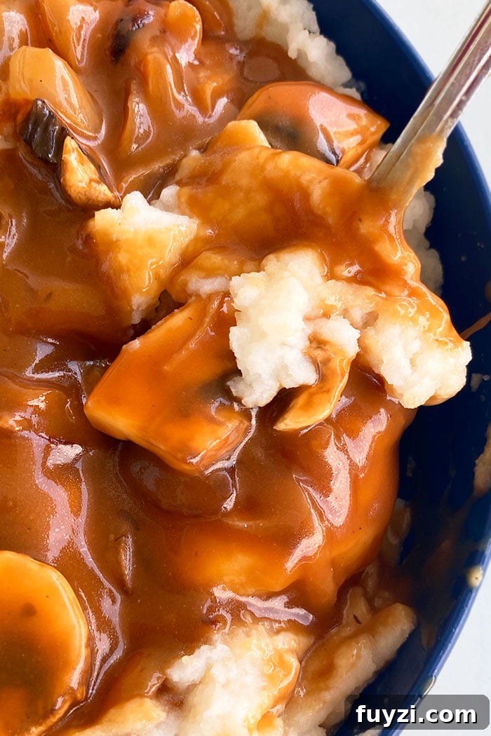 Closeup of Best Mushroom Gravy with Mashed Potatoes in Blue Bowl
