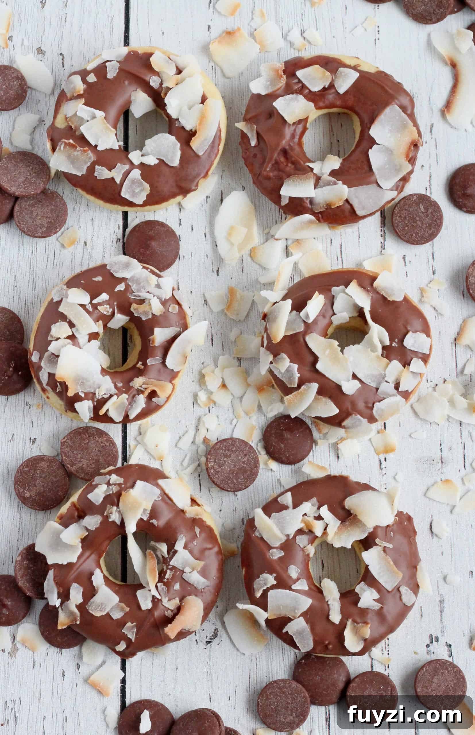 Baked Mini Donuts Recipe with Chocolate Glaze 2 baked donut covered in chocolate and coconut flakes