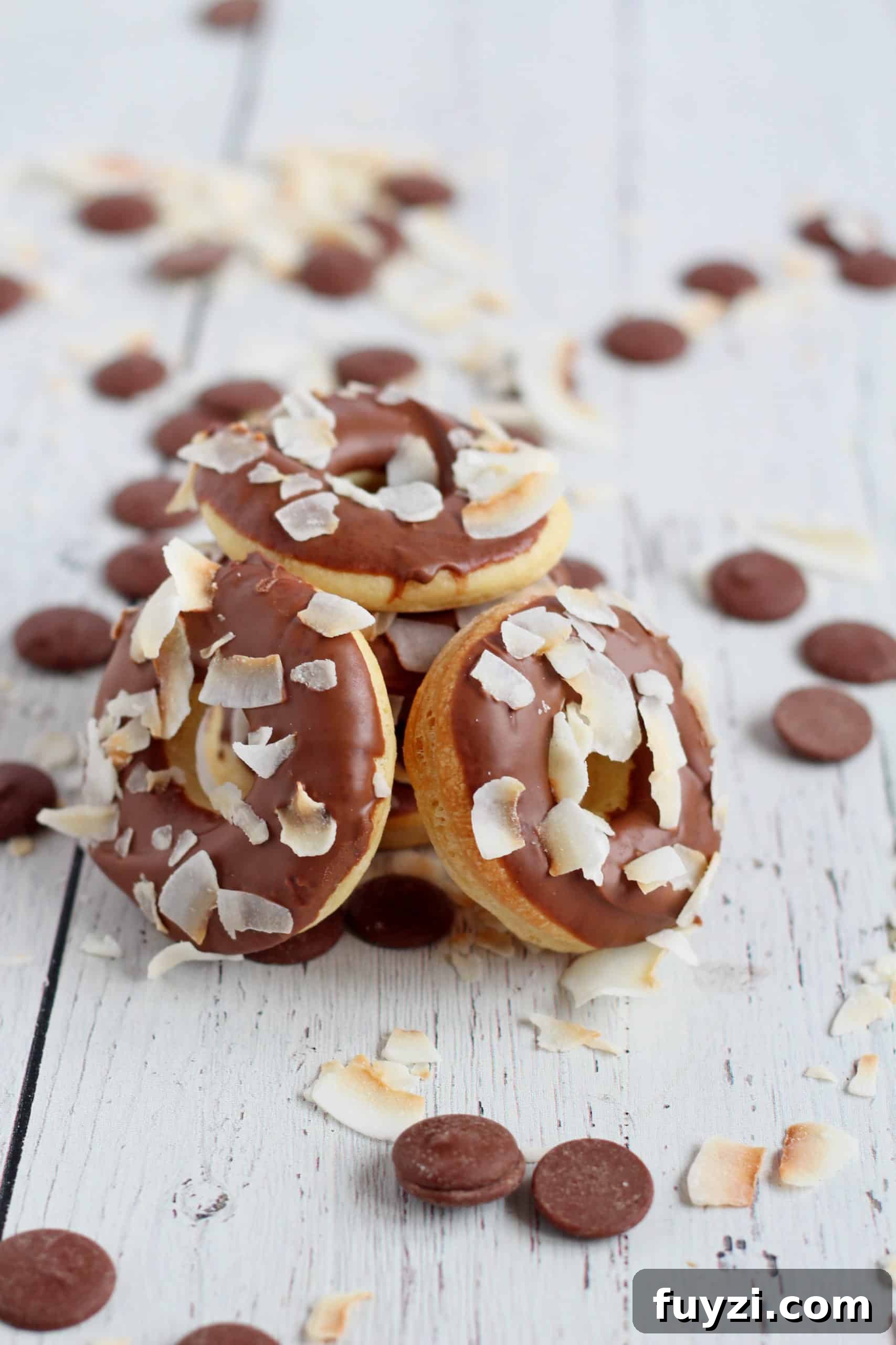 Baked Mini Donuts Recipe with Chocolate Glaze 4 donuts baked in oven with chocolate glaze and toasted coconut flakes