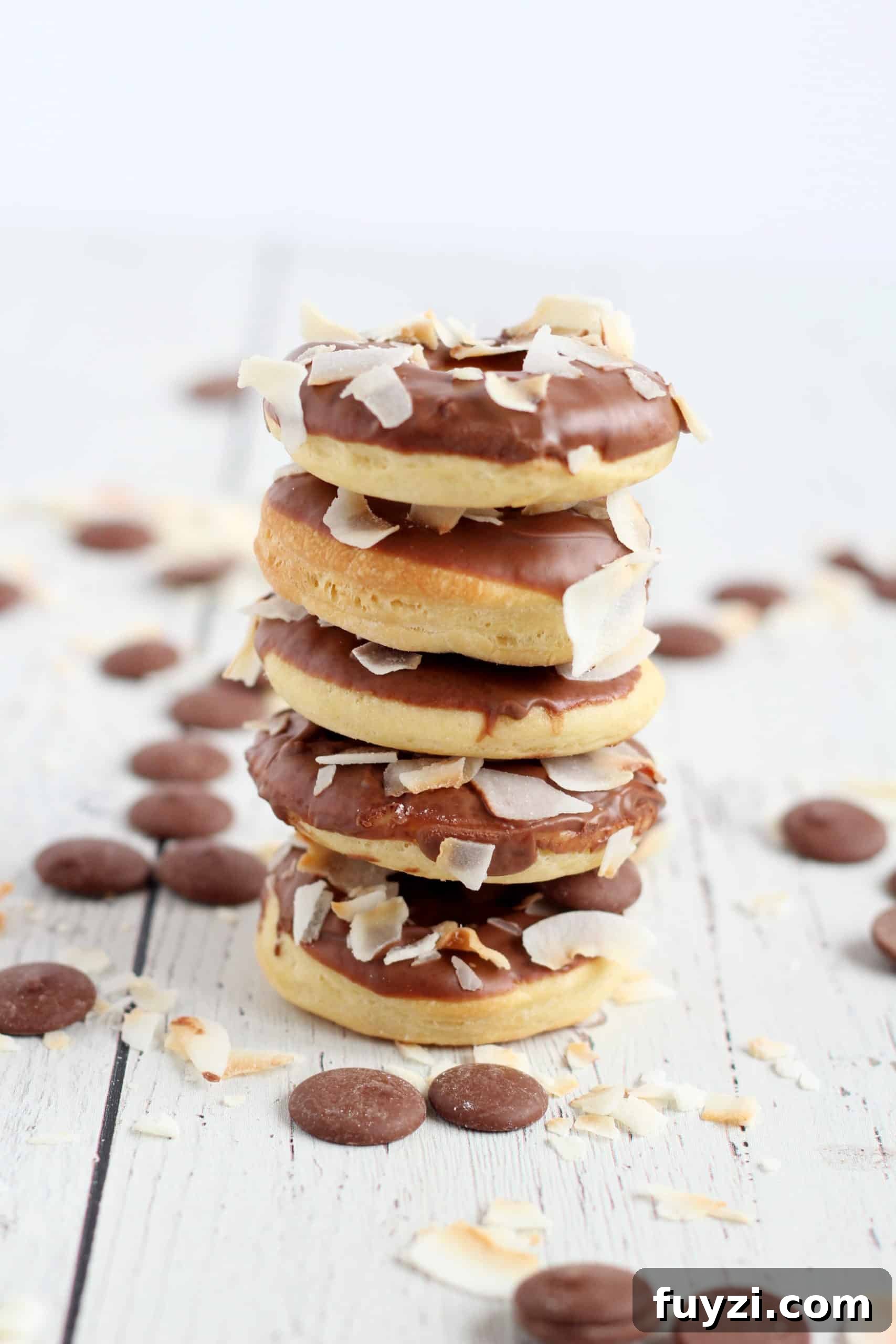 Baked Mini Donuts Recipe with Chocolate Glaze 5 five baked donuts glazed with chocolate stacked on each other