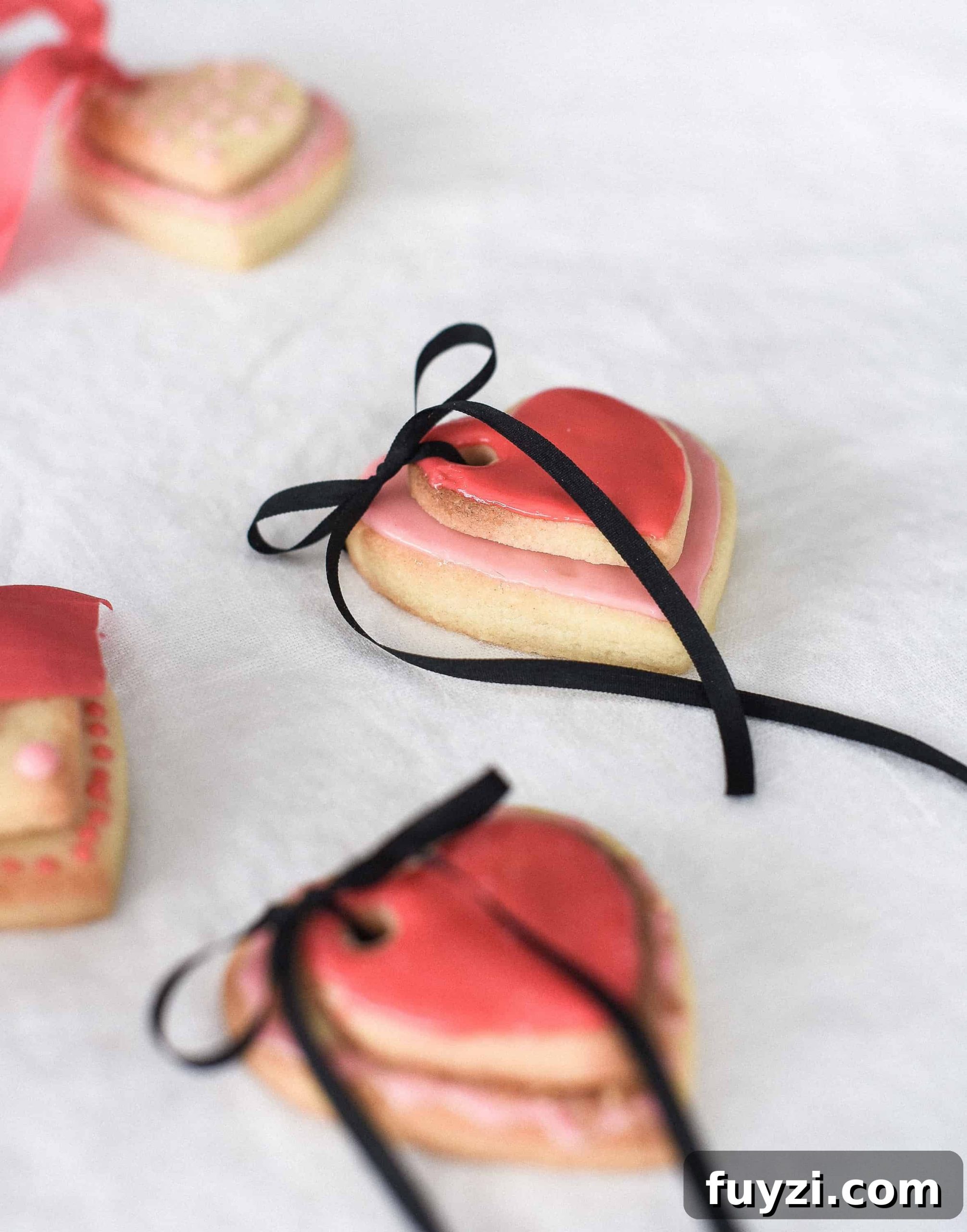 These Valentine’s Day sugar cookies are topped with simple royal icing and sprinkles and couldn’t be cuter! Use a little ribbon to turn these Valentine’s Day sugar cookies into the sweetest Valentine treat!