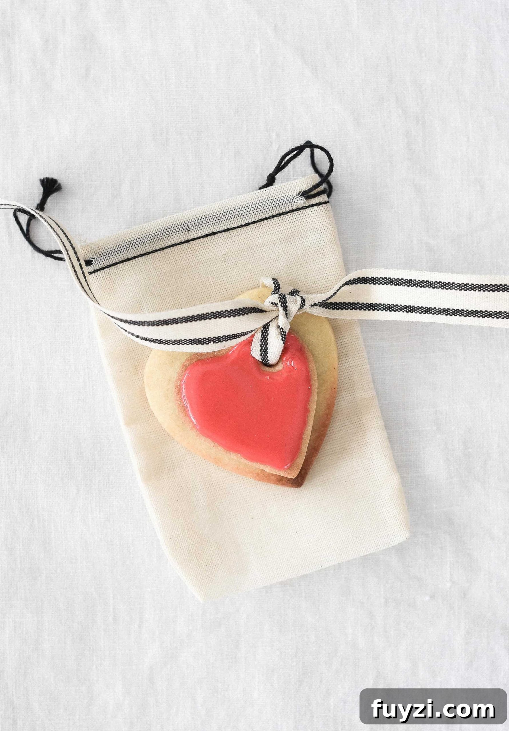 These Valentine’s Day sugar cookies are topped with simple royal icing and sprinkles and couldn’t be cuter! Use a little ribbon to turn these Valentine’s Day sugar cookies into the sweetest Valentine treat!