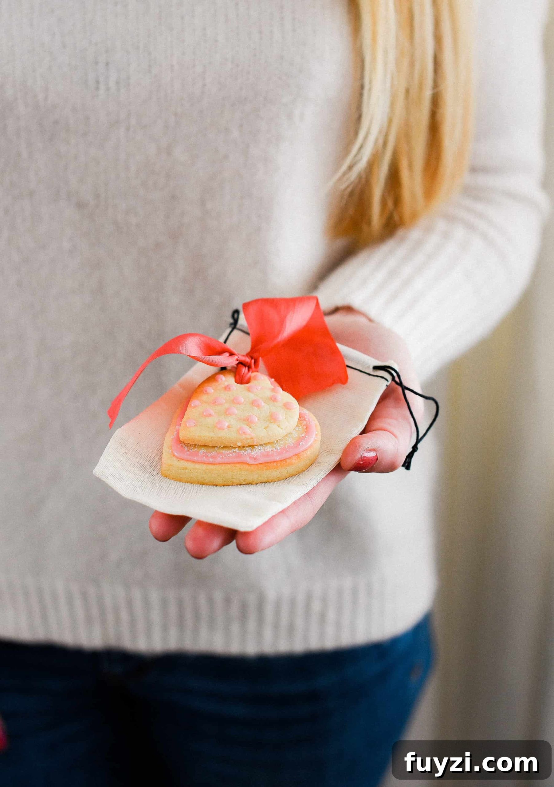 These Valentine’s Day sugar cookies are topped with simple royal icing and sprinkles and couldn’t be cuter! Use a little ribbon to turn these Valentine’s Day sugar cookies into the sweetest Valentine treat!
