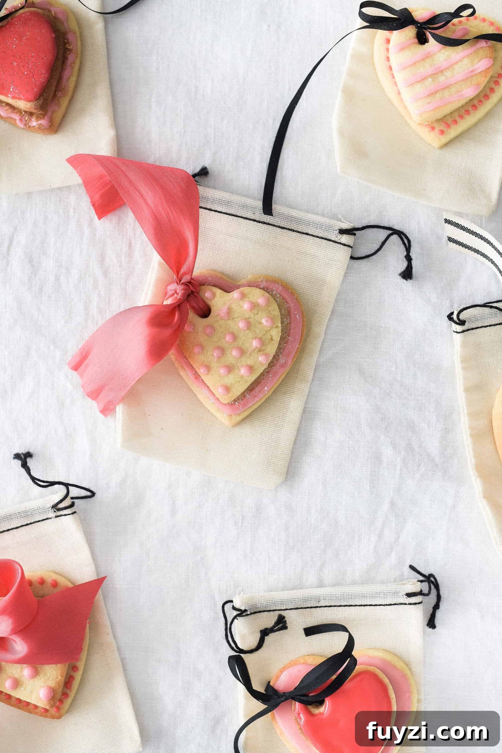 These Valentine’s Day sugar cookies are topped with simple royal icing and sprinkles and couldn’t be cuter! Use a little ribbon to turn these Valentine’s Day sugar cookies into the sweetest Valentine treat!