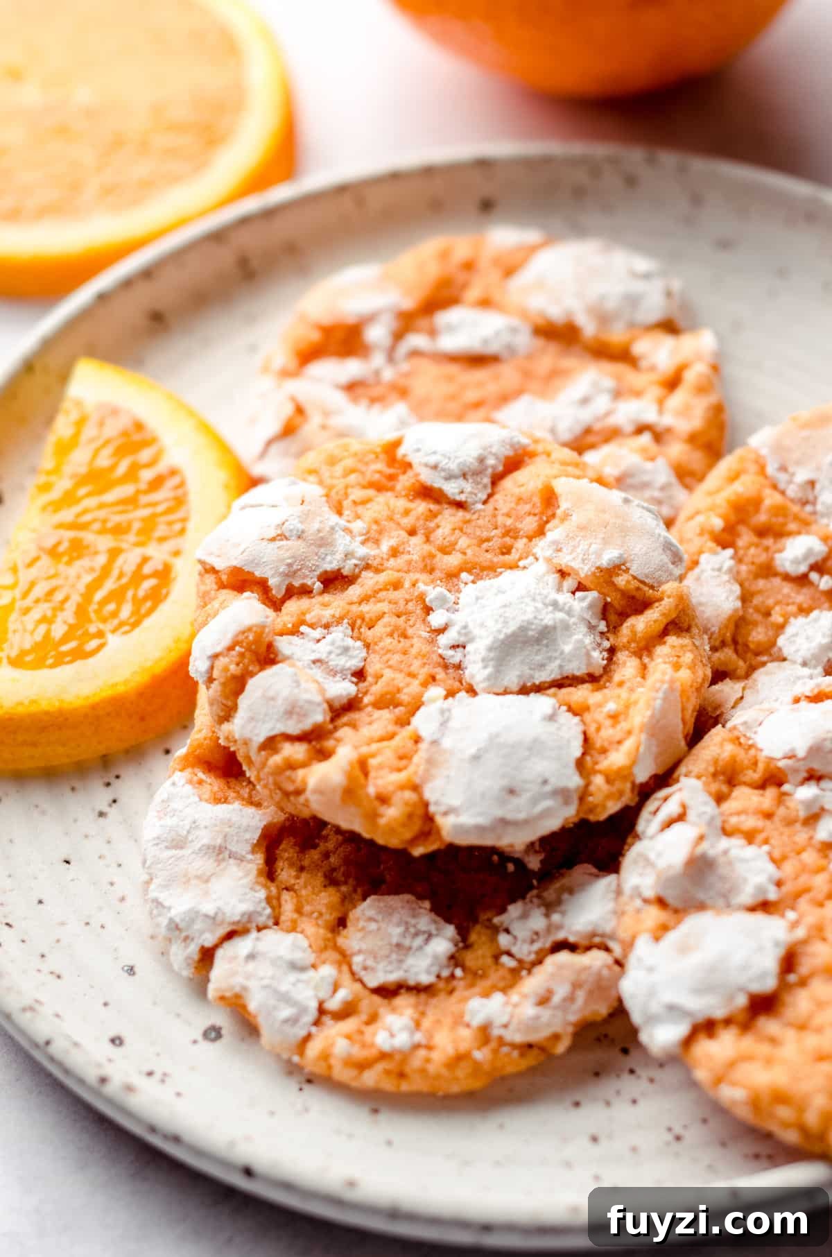orange creamsicle cookies on a plate with orange slices