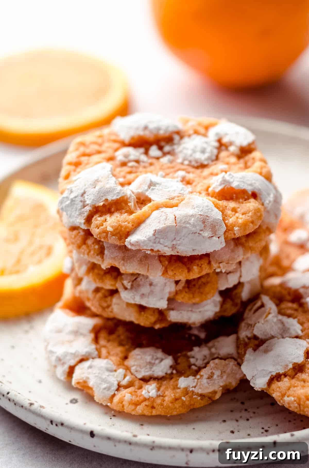stack of orange creamsicle cookies on a plate