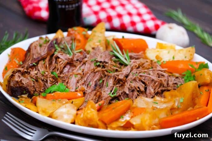 Slow-Cooked Guinness Pot Roast Recipe 3 a serving plate with shredded Guinness pot roast with veggies