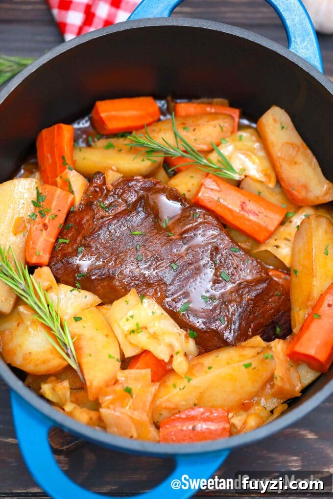 Slow-Cooked Guinness Pot Roast Recipe 9 Guinness pot roast with potatoes and cabbage in a cast iron Dutch oven