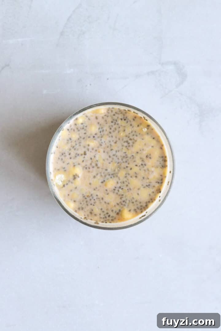 Overhead photo of a glass jar with un-set pumpkin chia seed pudding