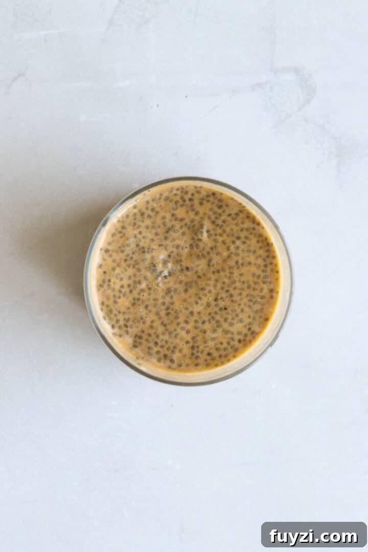 Overhead photo of a glass jar containing finished pumpkin chia seed pudding