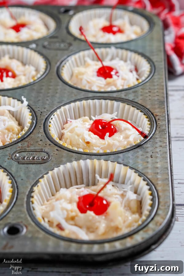 Coconut Rum Malibu Muffins with Pineapple Glaze Recipe 5 Maraschino cherries and coconut is pressed into the top of the muffins before baking.