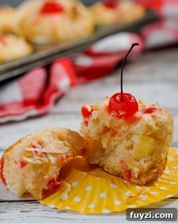 Coconut Rum Malibu Muffins with Pineapple Glaze Recipe 7 A muffin torn in two pieces.
