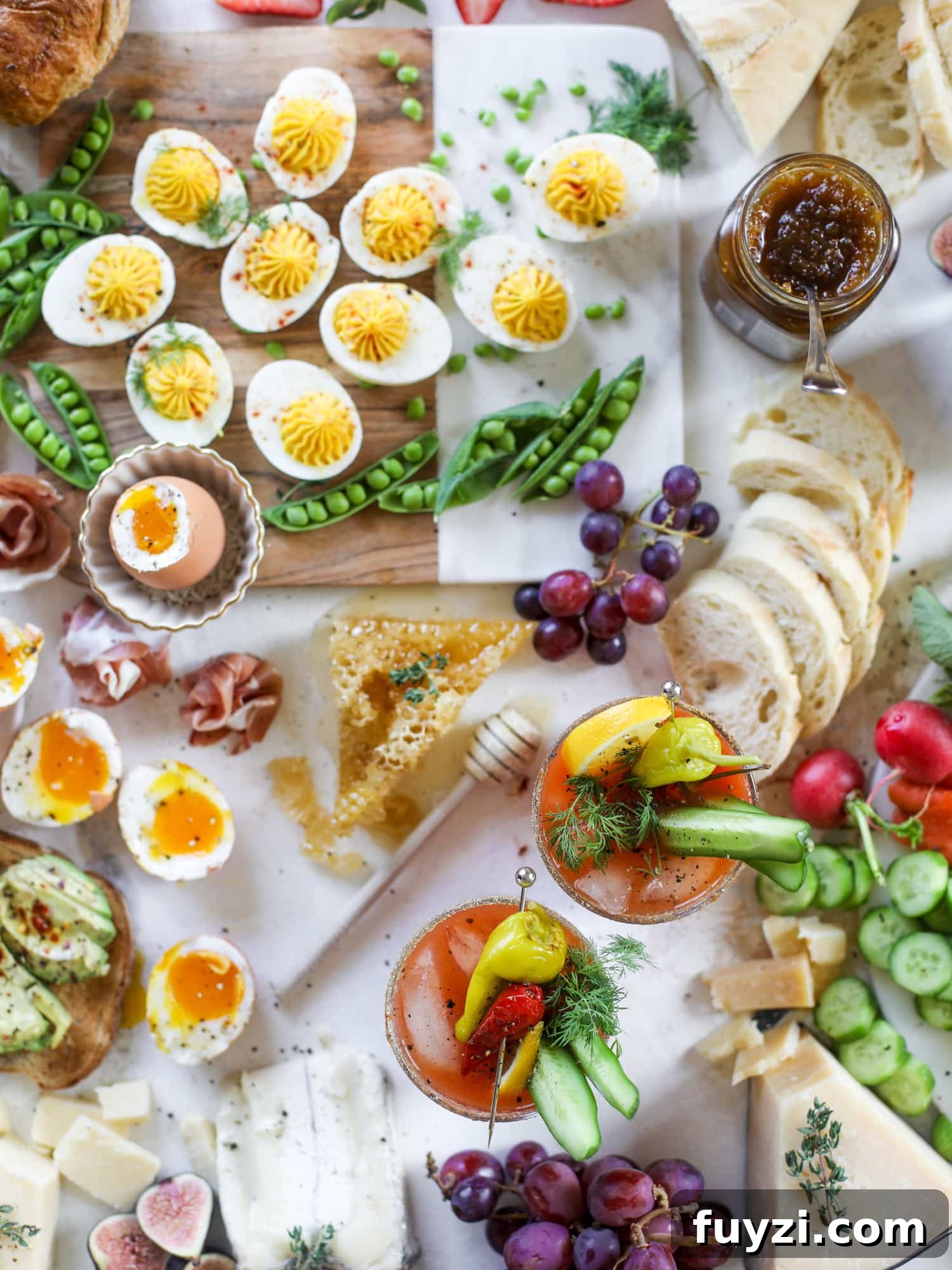 The highlight of this Easter brunch board are the deviled eggs and soft boiled eggs! Add some avocado toast, donuts and bloody marys and you've arrived. I howsweeteats.com #brunch #board