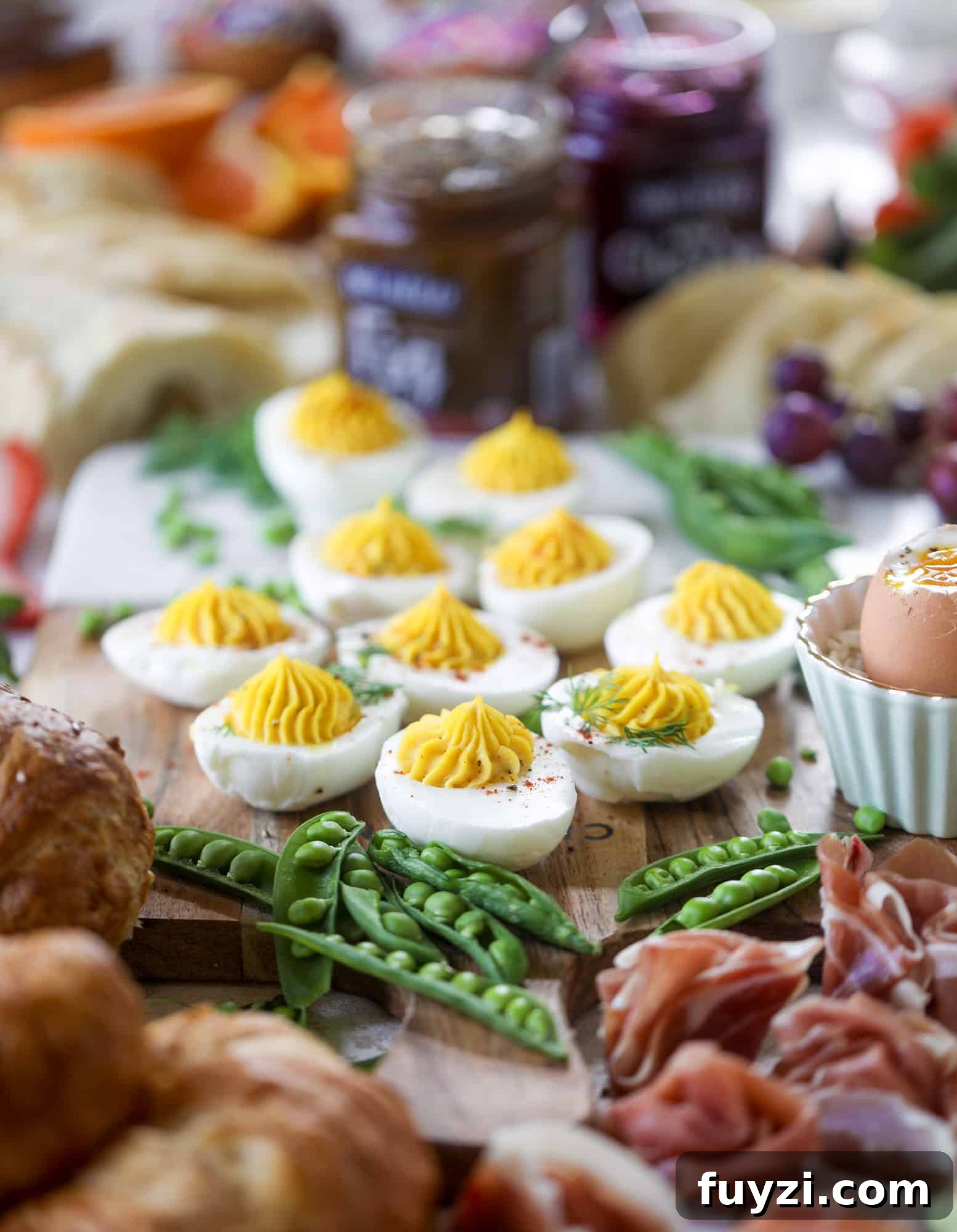 The highlight of this Easter brunch board are the deviled eggs and soft boiled eggs! Add some avocado toast, donuts and bloody marys and you've arrived. I howsweeteats.com #brunch #board