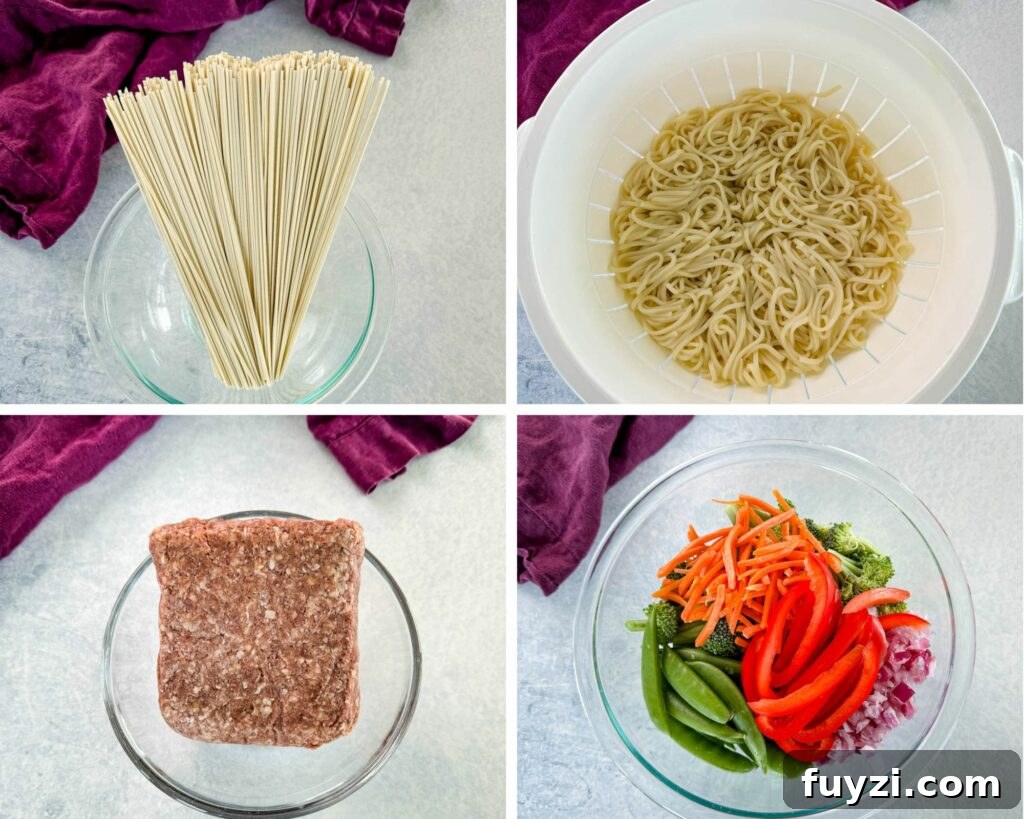lo mein noodles, raw ground beef, and fresh vegetables in separate bowls