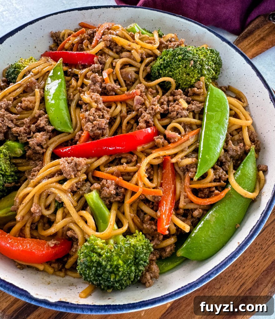 ground beef lo mein and vegetables in a white bowl