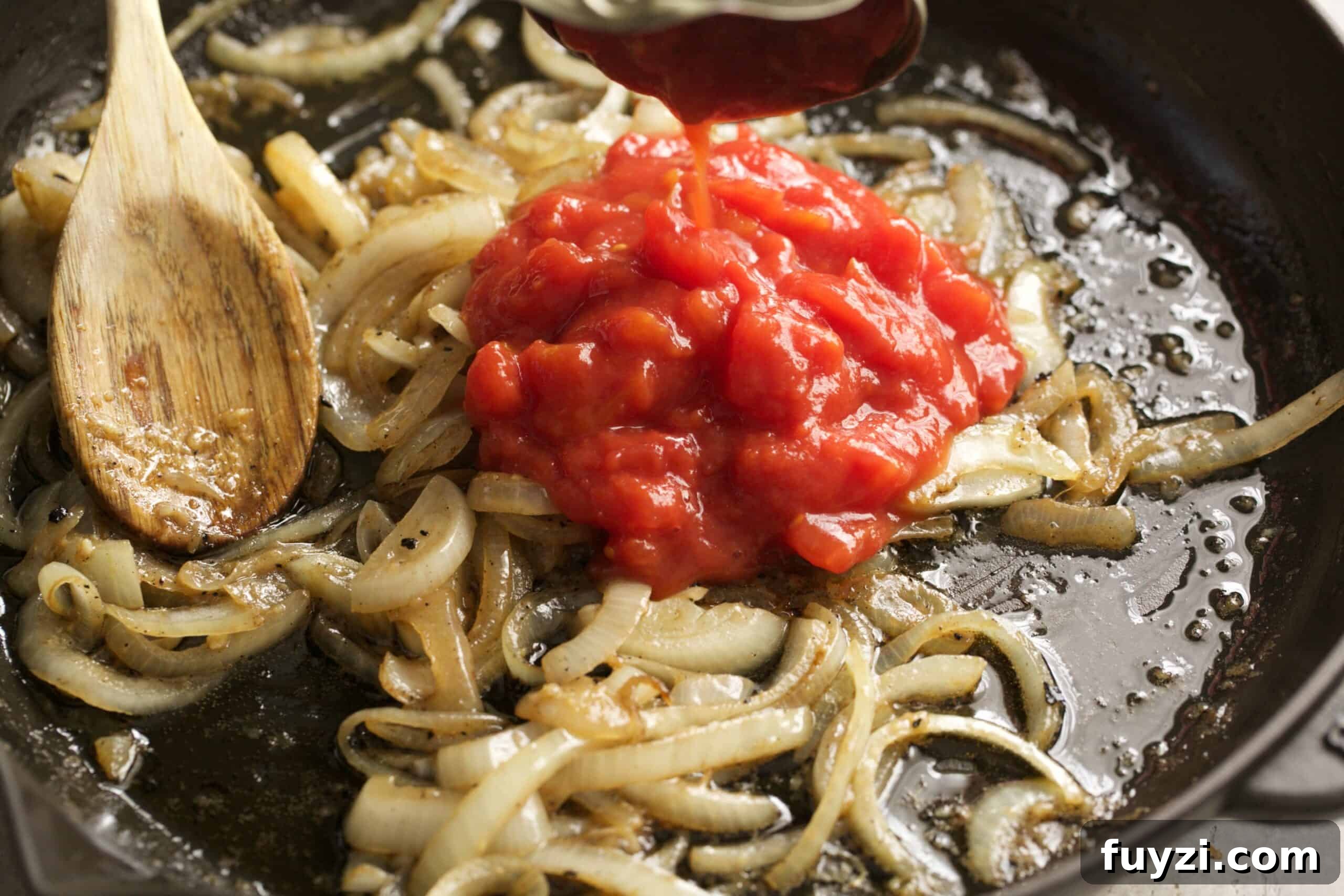 onion and crushed tomatoes in a pan