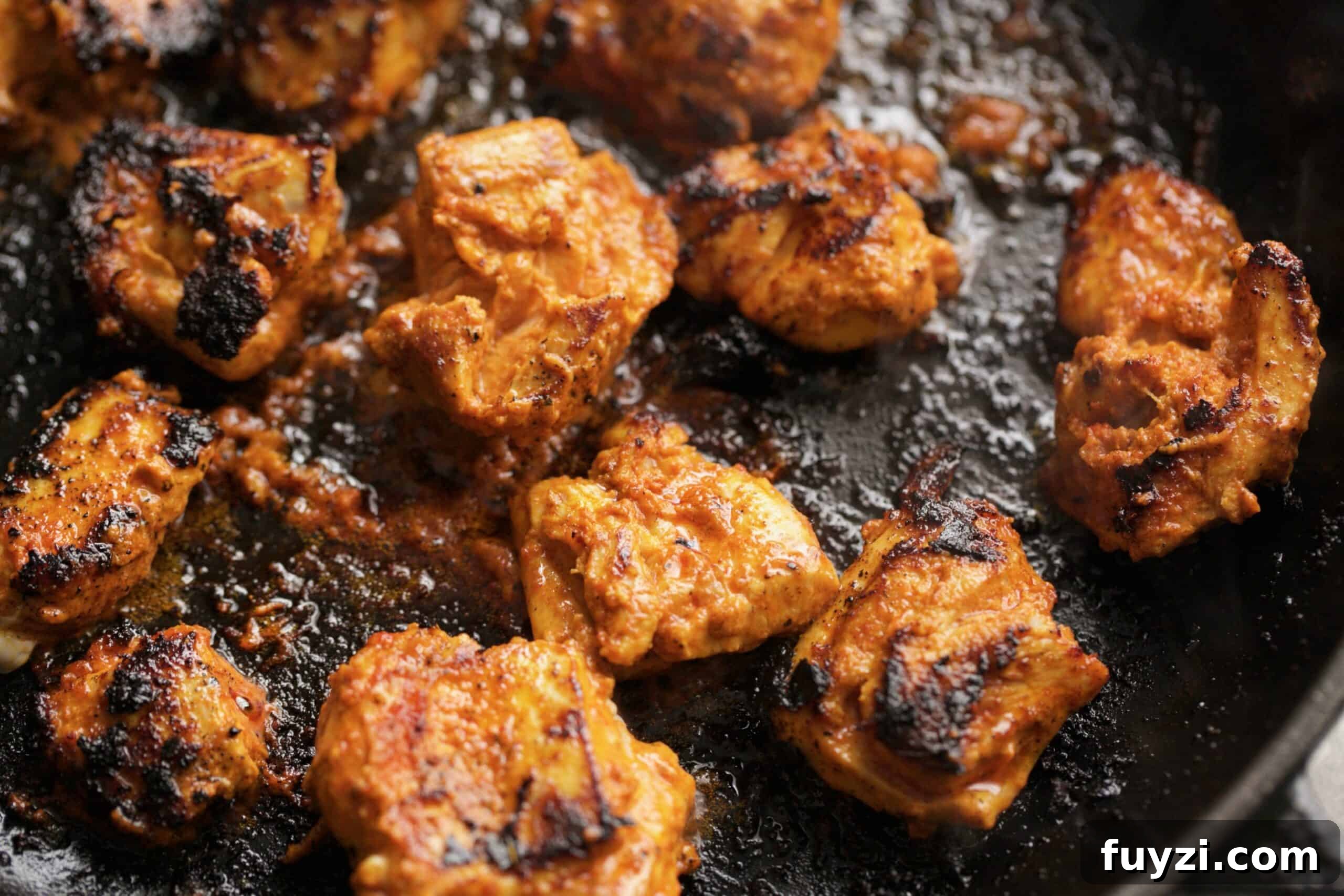 chicken being cooked in a pan