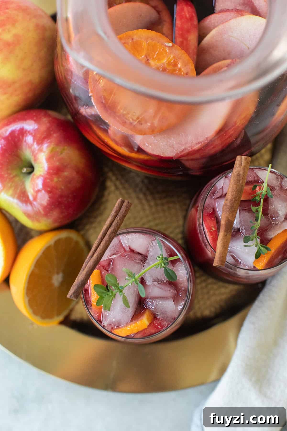 Spiced Autumn Apple and Pear Sangria Recipe 8 Fall spice sangria recipe on a tray garnished with a cinnamon stick.