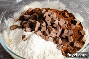 Fudgy Chunky Chocolate Chip Brownies Recipe 7 Chocolate chunks added to the brownie mix in a glass bowl