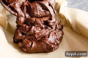 Fudgy Chunky Chocolate Chip Brownies Recipe 8 Pouring the brownie mixture into a parchment paper lined baking tray