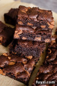 Fudgy Chunky Chocolate Chip Brownies Recipe 12 Chunky Chocolate Chip Brownies stacked up on brown parchment paper