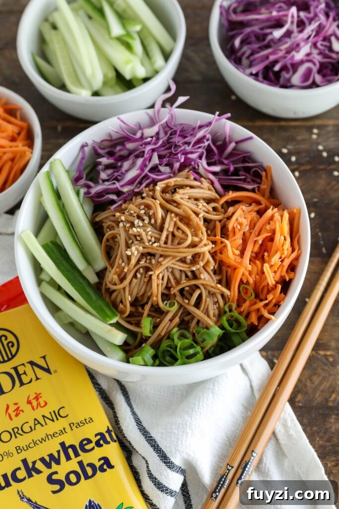 Vegan Bibim Guksu (Korean Spicy Cold Noodles) served in bowl with chopsticks