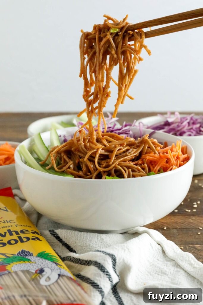 Vegan Bibim Guksu (Korean Spicy Cold Noodles) served in bowl with chopsticks